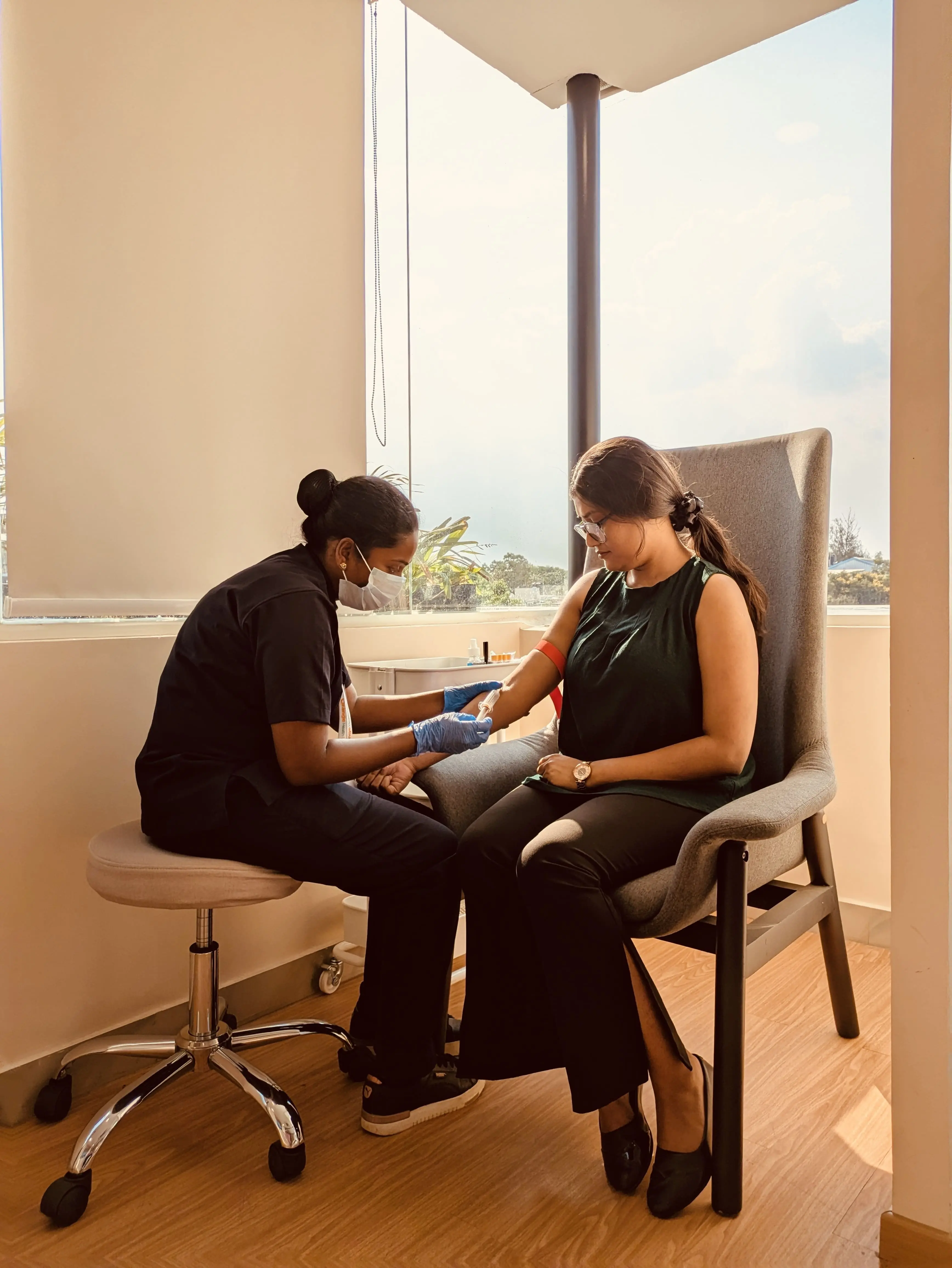 Patient seated in branded collection room